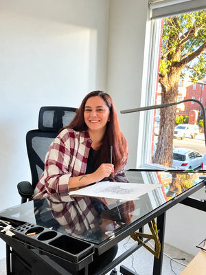 Maria Vallverdu Sabia at her desk working on an artpiece